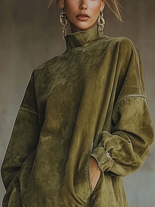 Close-up of olive green suede dress featuring high neck collar and zipper sleeve detail