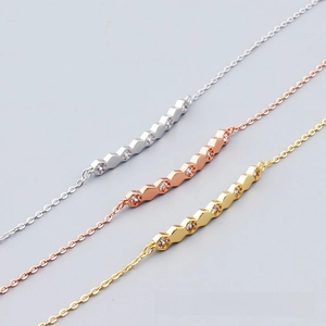 Detailed close-up showing geometric zigzag bracelets in silver, gold, and rose gold finishes