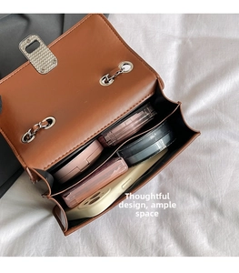 Detailed interior of brown crossbody bag showing spacious compartments and storage capacity