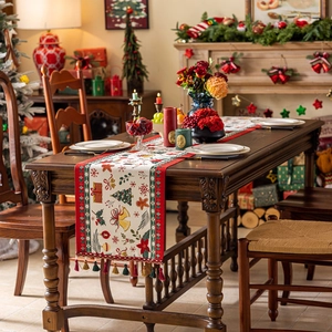 Christmas table runner with jacquard holiday patterns and elegant red tassels for dining decor