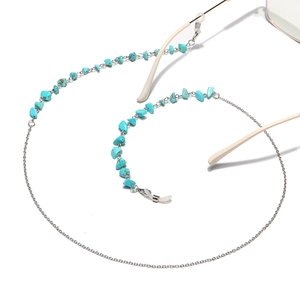Detailed shot of silver metal eyewear chain featuring natural turquoise stone accents