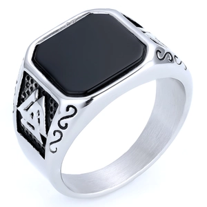 Macro detail of men's vintage Masonic ring with black onyx and Valknut engravings