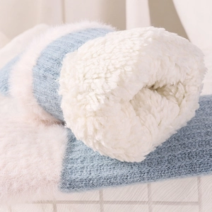 Cozy winter blue striped knitted socks with thick white faux sherpa fleece lining inside