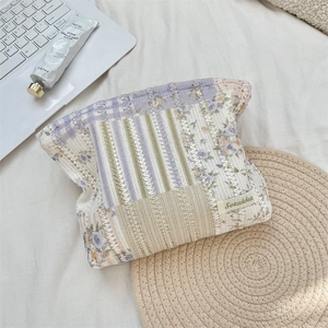 Macro view of floral quilted cotton makeup bag with knit texture and Sozakka label