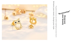 Detailed view of owl stud earrings with gold plating and sparkling white zircon stones
