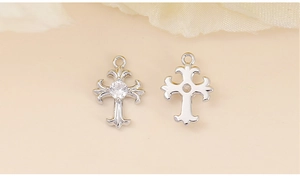 Macro shot of silver cross pendant with clear zircon inlay and metal back detail