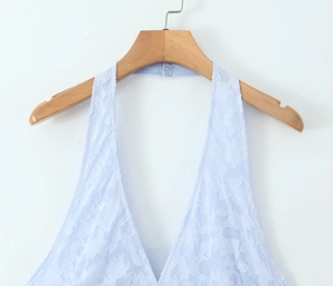 Detail of light blue floral lace texture and deep V-neckline on backless dress