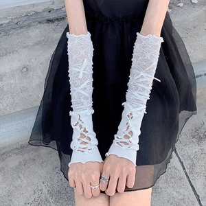 Close-up of white lace Y2K sleeve gloves featuring ribbon bow ties on the arm