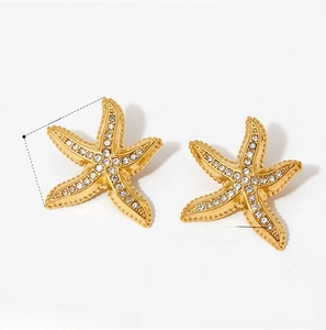 Detail view of 13mm gold starfish earrings with sparkling zircon and dimension labels