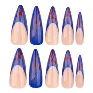 Extra long stiletto press-on nails with blue and red flame designs on a nude base