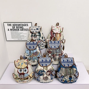 Ethnic style drawstring backpacks with animal patterns like owl and rabbit in a group display