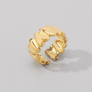Detailed view of golden heart-shaped continuous pattern on adjustable open ring band
