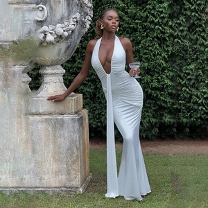 Detailed view of elegant white halter neck maxi dress with deep V-neck and ruffled waist