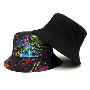 Reversible bucket hat with black solid side and colorful graffiti paint splatter pattern