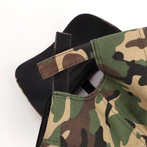 Detail of adjustable hook-and-loop strap on the back of a digital camo baseball cap