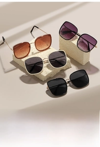Selection of oversized square sunglasses in gradient tea, purple, black, and cream frames