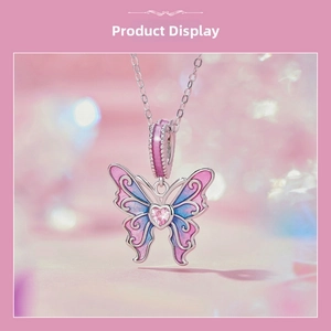 Macro detail of S925 silver butterfly pendant with pink heart stone and enamel