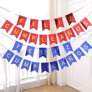 Detail of red and blue Feliz Cumpleaños banners with gold letters for party decoration