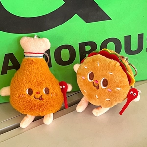 Close-up of cute plush french fries and burger charms with embroidered faces and spoons