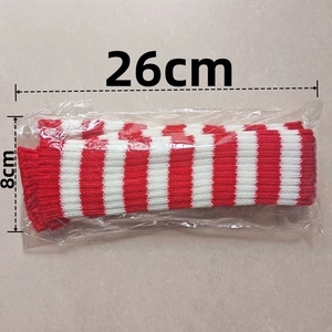 Detail of red and white striped knit arm warmers in clear packaging measuring 26x8cm