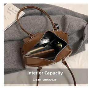 Interior view of the brown patent leather bag showing capacity for phone and cosmetics