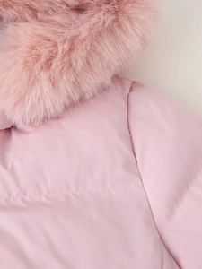 Close-up of premium pink faux fur hood trim and quilted stitching on padded jacket