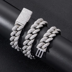 Close-up of a silver Cuban link necklace encrusted with zircon stones and a box clasp