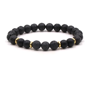 Macro view of 8mm black lava rock and matte beads with golden metal spacers on elastic cord
