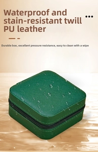 Detail of waterproof dark green PU leather jewelry box showing textured surface and zipper