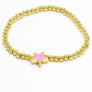 Detail of a gold beaded bracelet featuring a pink enamel star pendant with metal shine