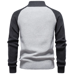 Detail of grey raglan sleeve knit sweater with ribbed cuffs and textured knit pattern