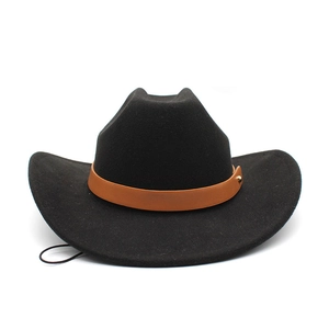 Detail of black wool felt cowboy hat with brown leather band and metallic studs