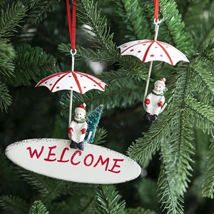 Christmas snowman umbrella hanging ornaments with Welcome sign on a lush tree branch