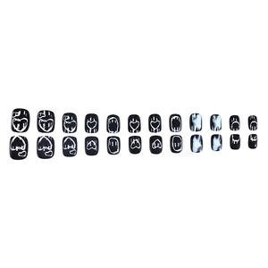 Press-on nail set featuring black glossy finish with white graffiti heart patterns and marble texture