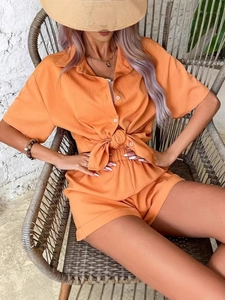 Women's orange two-piece casual set with short sleeve shirt and crinkle fabric shorts