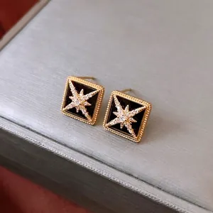 16K gold plated diamond shape stud earrings with black inlay and sparkling star motif