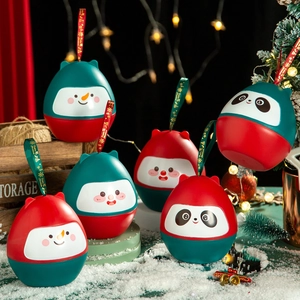 Detail of snowman and panda Christmas tumblers with silk ribbons in a snowy setting