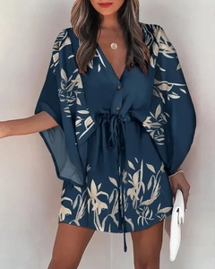 Detail of V-neck ruffled sleeve dress with navy leaf print and drawstring waist tie
