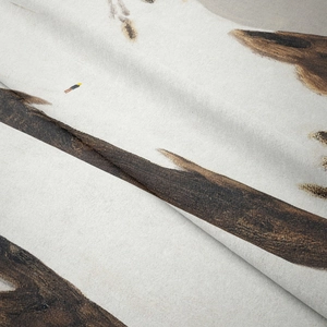 Close-up of bohemian printed tapestry showing cream fabric texture and animal patterns