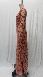 Detail of red floral sequins on mesh long sleeve evening dress with fitted silhouette