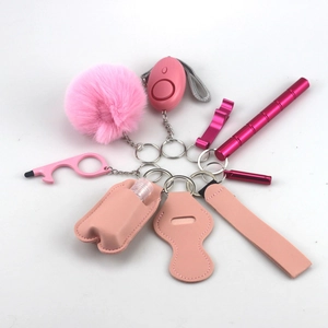 Pink self-defense keychain set including safety alarm, faux fur pompom, and tactical pen