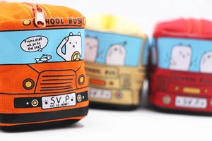 Detail of school bus canvas pencil cases in orange yellow and red with zipper closure
