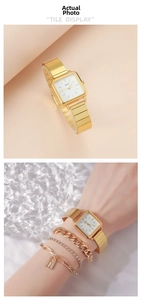 Close-up of golden square watch and matching bracelets on a textured glass background
