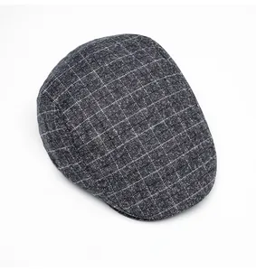 Top view of a gray plaid flat cap showing detailed British vintage wool texture