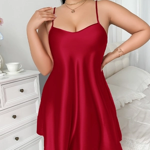 Elegant deep red satin camisole nightdress with slim straps and V-neckline in bedroom