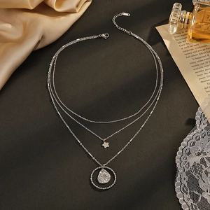 Three-layer silver stainless steel necklace with star and round hammered metal pendants