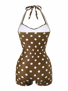 Detail of brown polka dot one-piece swimsuit featuring backless lace-up halter design