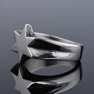 Macro shot of polished silver stainless steel star ring with sharp reflective details