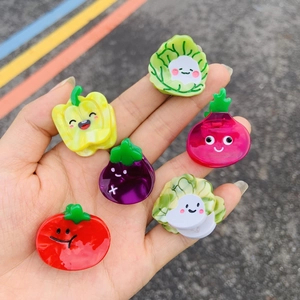 Detailed view of colorful acetate vegetable hair clips with cute cartoon smiling faces