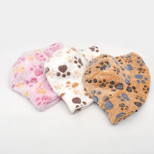 Detailed view of plush bucket hats with cat paw prints in pink, white, and tan colors